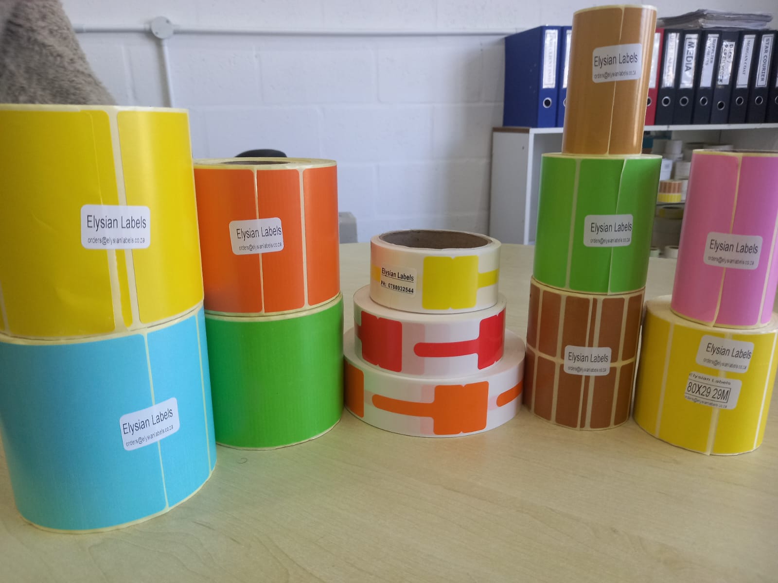 Range of Elysian Labels face stock colours — yellow, blue, orange, green, pink, brown and gold label rolls